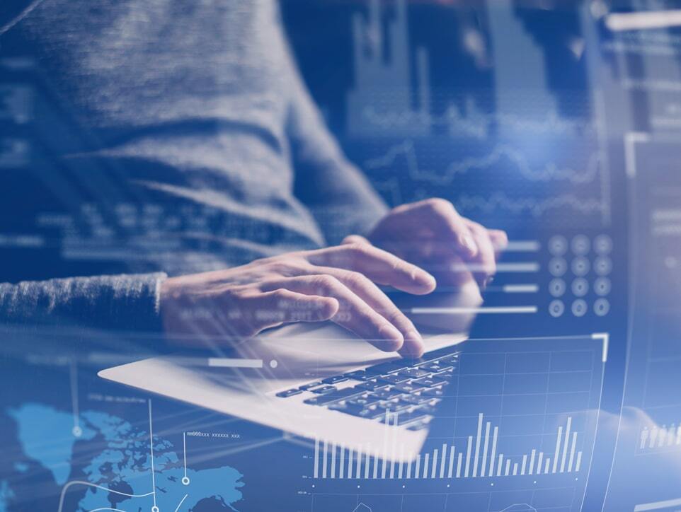 A laptop with blue overlay of various graphs and charts