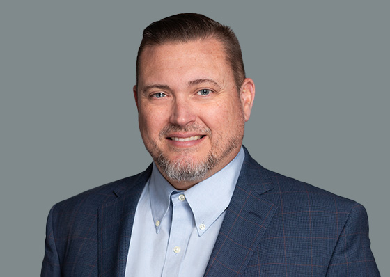 A man, David Buck,  in a blue suit jacket.