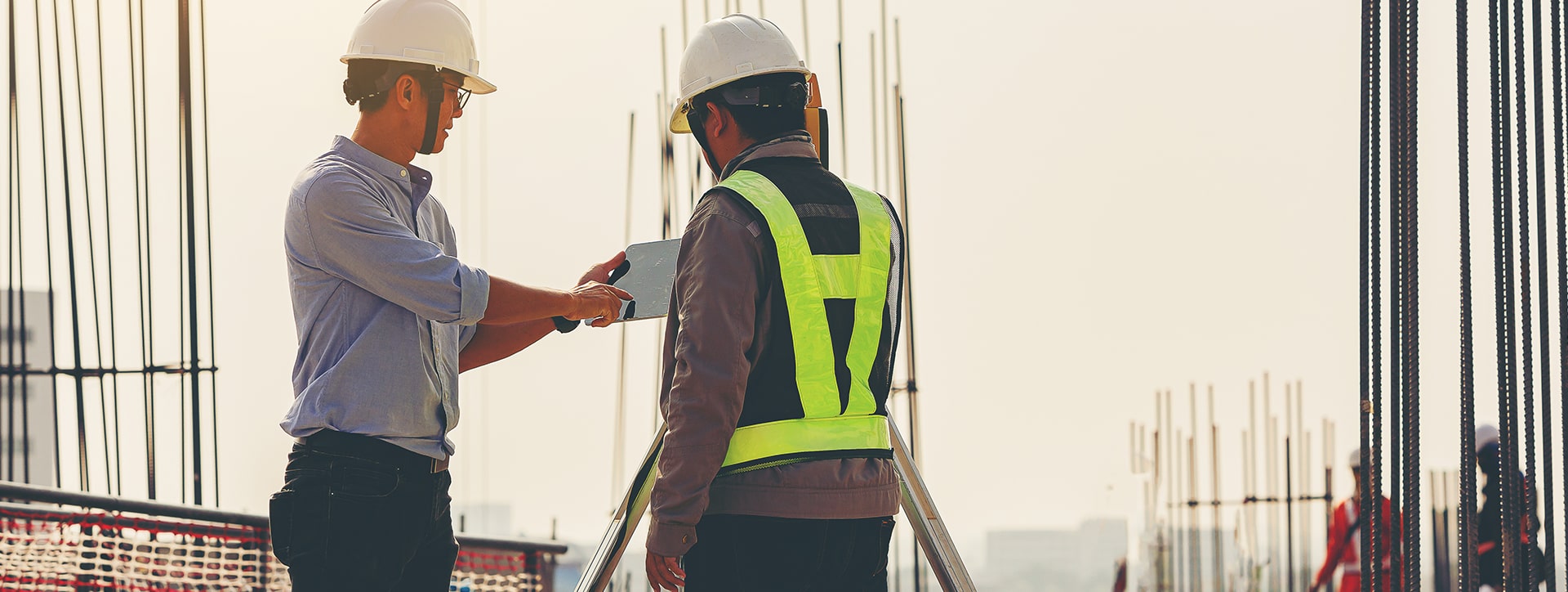 Two construction workers on a construction site.
