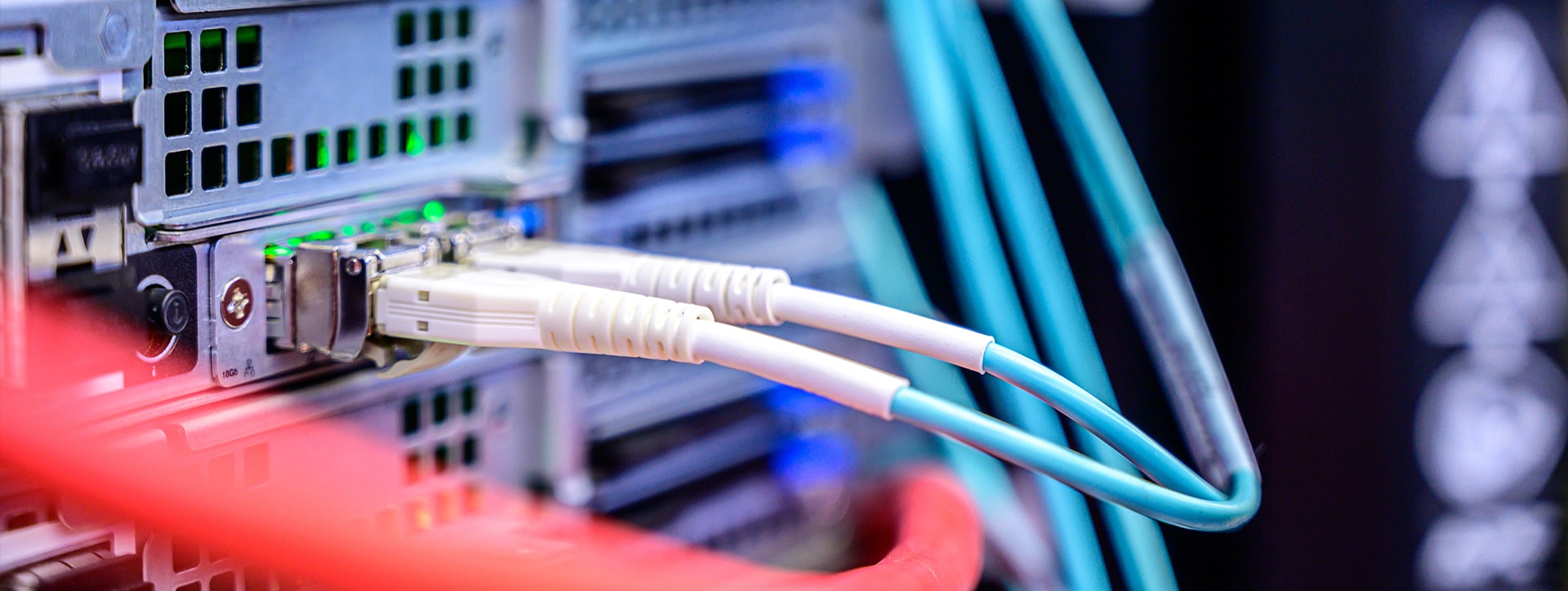 A close up of a network switch with two ethernet cables plugged in. 